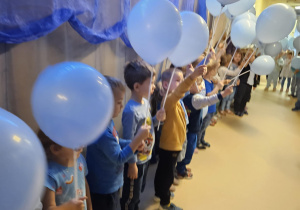Na zdjęciu widać dzieci które trzymają balony niebieskie z okazji Międzynarodowy Dzień Praw Dziecka.