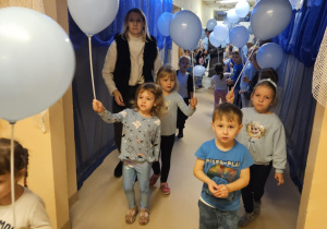 Na zdjęciu widać dzieci które trzymają balony niebieskie z okazji Międzynarodowy Dzień Praw Dziecka.