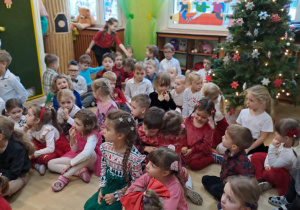 Na zdjęciu widać dzieci przy wspólnym kolędowaniu.