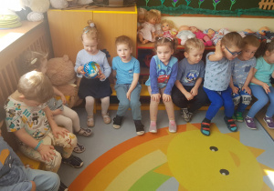Na zdjęciu widać dzieci które będą przechodzić po podkładkach sensorycznych.