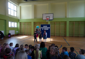 Na zdjęciu widać dzieci na scenie które recytują wiersz.