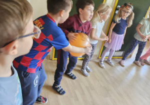 Na zdjęciu widać dzieci które wykonują zabawy ruchowe.