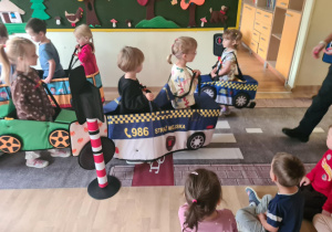 Na zdjęciu widać dzieci które uczą się przestrzegania zasad obowiązujących na ulicy.