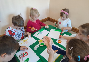 Na zdjęciu widać dzieci jak rysują kreatywną pracę plastyczną.