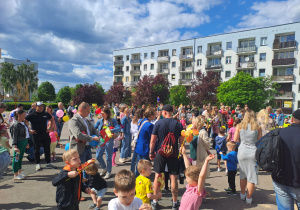 Na zdjęciu widać dzieci i rodziców na pikniku rodzinnym.