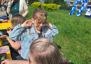 Na zdjęciu widać dzieci i rodziców na pikniku rodzinnym.