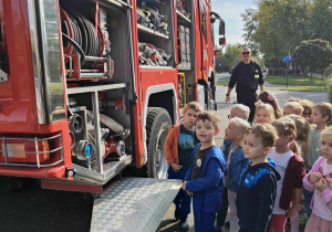 Na zdjęciu widać dzieci które oglądają wyposażenie Wozu Strażackiego.